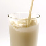 Pouring water into a shaker bottle for plant protein preparation