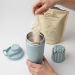 Scooping 30g of EatProtein plant protein powder