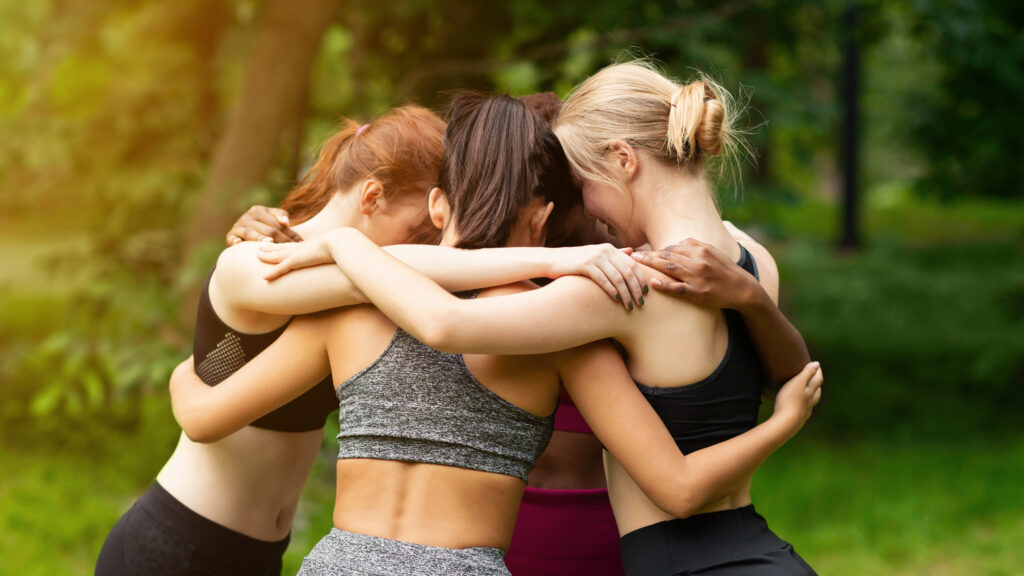 Women supporting each other after an outdoor workout