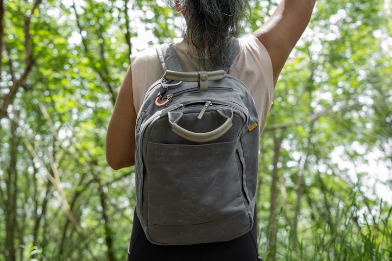 Woman hiking outdoors with backpack — fuel your adventures with high protein snacks