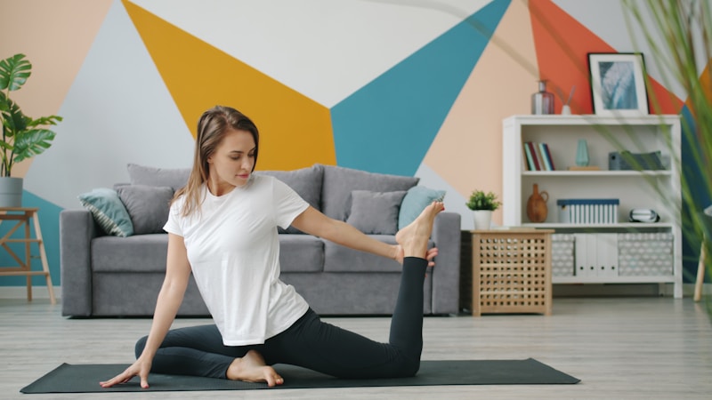 Woman doing yoga and stretching at home — flexible, strong, confident