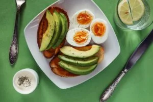 Open avocado sandwiches with poached eggs, a high protein breakfast idea