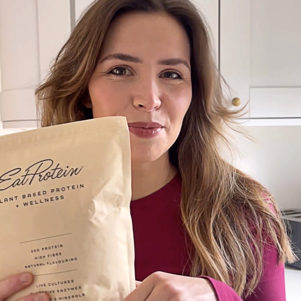 Customer holding EatProtein Plant Protein powder