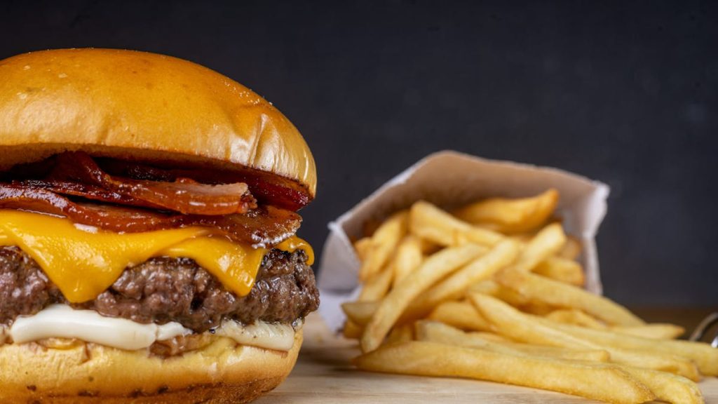 Cheeseburger with fries on a board — ultra-processed food example