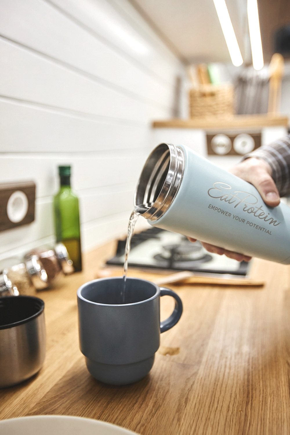 Pouring a hot drink from the insulated bottle into a mug