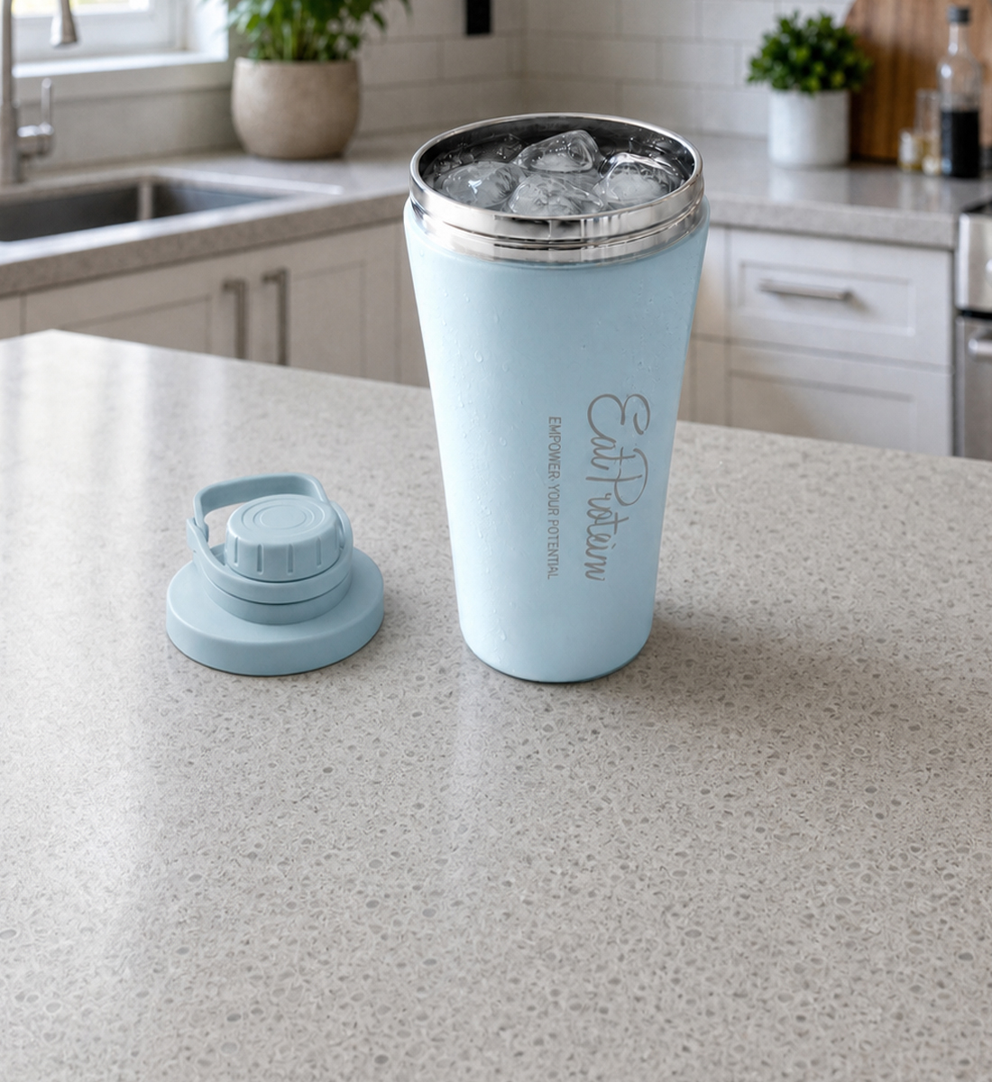The insulated bottle filled with ice on a kitchen counter