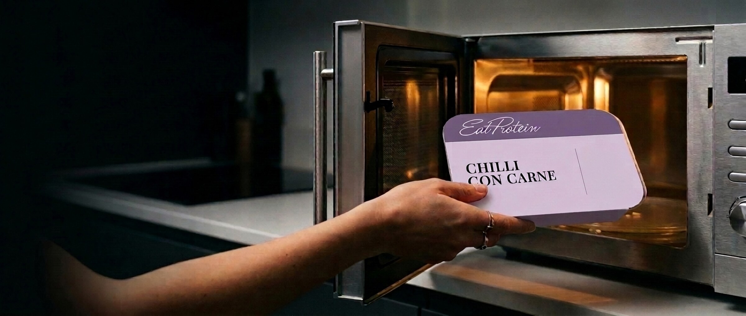 EatProtein high-protein ready meal going into the microwave